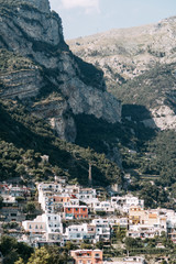 The coast of Positano, Amalfi in Italy. Panorama of the evening city and the streets with shops and cafes. Houses by the sea and the beach. Ancient architecture and temples