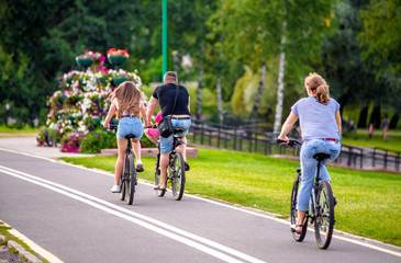 Fototapeta premium Cyclists ride on the bike path in the city Park 