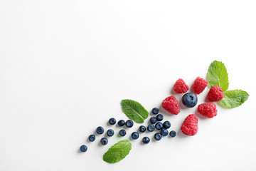Naklejka na ściany i meble Delicious ripe berries on white background, top view