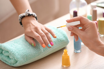 Obraz na płótnie Canvas Young woman getting professional manicure in beauty salon, closeup