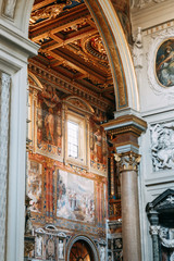 Obraz premium Salvatore Church in Rome, view from outside and inside. Frescoes and statues, architectural elements. A historic landmark, tourist destination. Ancient painting