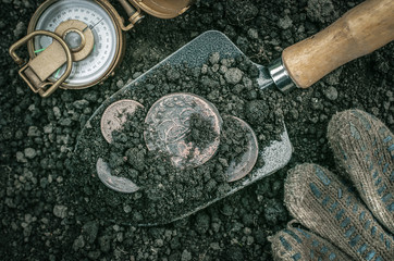 Russian empire ancient coins on the shovel and compass. Coins searching. Treasure hunting concept....