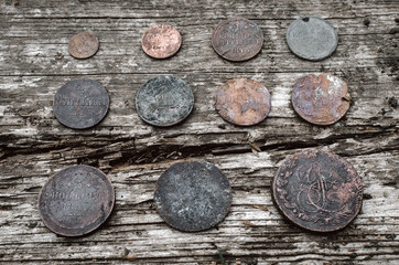 Old coins of Russian empire collection on wooden table background.