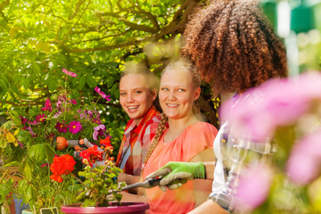 Three beautiful girls working in the garden