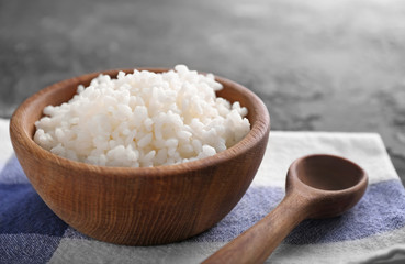 Bowl with boiled white rice on table