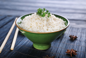 Bowl with boiled white rice on table