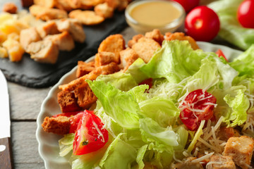Tasty Caesar salad on plate, closeup
