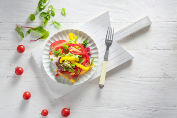 Plate with tasty vegetable salad on table
