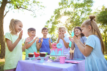 Cute little children celebrating Birthday outdoors