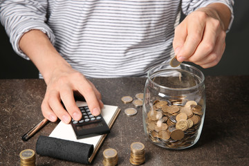 Man counting coins at table. Savings concept