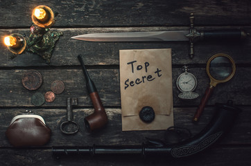 Top secret documents file, musket gun, dagger, magnifying glass, smoking pipe, pocket watch and...