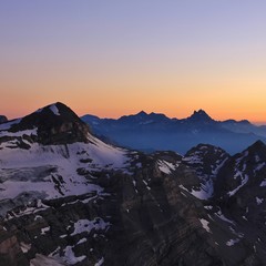 Colorful sky over Mount Tete Ronde and Dents Du Midi. View from Glacier 3000. Diablerets Glacier....