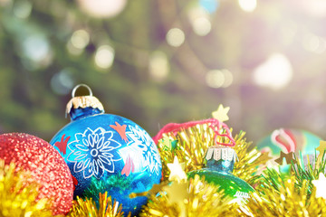 Old  New Year ball and tinsels lying in box in front of a Christmas tree