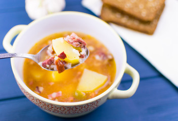 Soup of saltwort. Soup from different types of sausages, olives, potatoes, tomato paste.