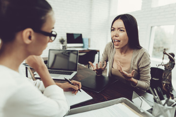 Young Upset Woman in Office with Lawyer in Glasses