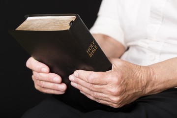 Senior Hands Holding a Bible