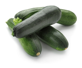 Ripe zucchinis on white background