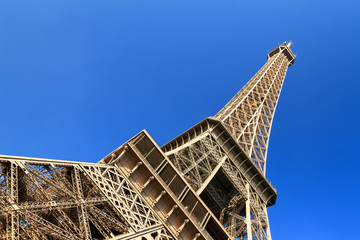 Beautiful view of the Eiffel tower seen from beneath with a blue sky in spring in Paris
