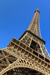Beautiful view of the Eiffel tower seen from beneath with a blue sky in spring in Paris
