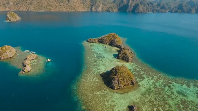 aerial footage small rocky islands in the lagoon with turquoise water. Busuanga, Palawan. coral reef and blue lagoon