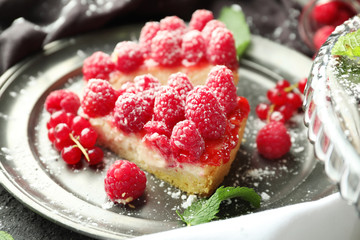 Pieces of delicious raspberry cheesecake on plate, closeup