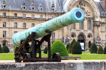 An ancient cannon at Les Invalides in Paris, France, on a beautiful day in spring