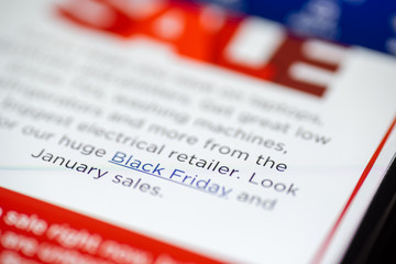 Black Friday Sale text on shopping app on smartphone screen closeup