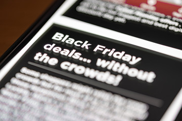 Black Friday Deals text on shopping app on smartphone screen closeup