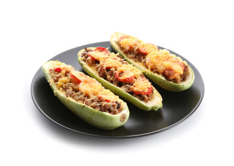 Plate with meat stuffed zucchini boats on white background