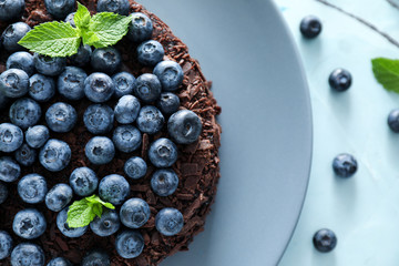 Delicious blueberry chocolate cake on plate, closeup