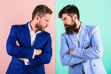 Businessmen stylish appearance jacket pink blue background. Tense face expression competitors. Business competition and confrontation. Business partners competitors in suits with tense bearded faces