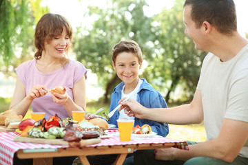 Happy family having picnic on summer day