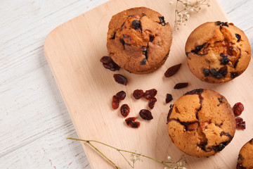 Tasty cranberry muffins on board