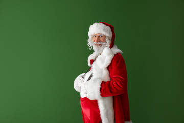 Portrait of Santa Claus on color background