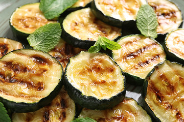 Tasty grilled zucchini on plate, closeup