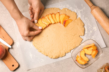 Woman preparing peach galette