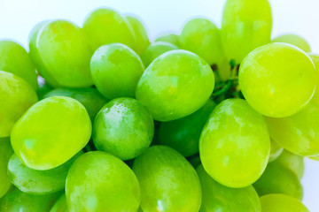 A bunch of the green grape isolated on white background. Grape close up backdrop.