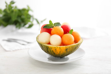 Bowl with fresh melon and watermelon balls on light table