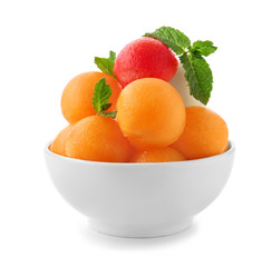 Bowl with fresh melon and watermelon balls on white background