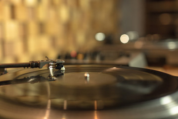 Playing vinyl in the studio on blurred background