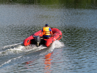 Man driving a motor boat. Lifeguard in a life jacket, rescue drowning, safety on the water, river...