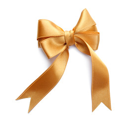 Beautiful bow made from golden ribbon on white background