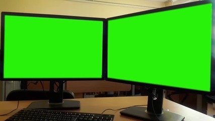 Working in office with double green screen PC