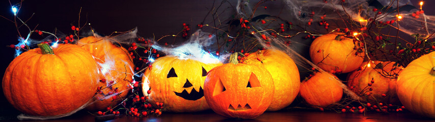 preparing for Halloween, cleaning and carving faces from pumpkins, pumpkins on a dark table with...