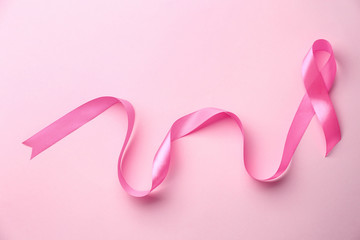 Pink ribbon on color background. Breast cancer concept