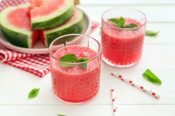 Glasses with fresh watermelon smoothie on white table