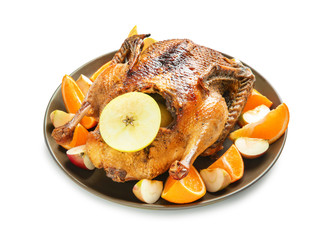 Tasty roasted duck with oranges and apples for Christmas dinner on white background
