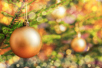 Christmas-tree decoration bauble on decorated Christmas tree bac