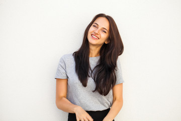 Happy brunette woman in gray t-shirt