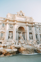 Fototapeta na wymiar The Trevi fountain in Rome, a beautiful sight. Ancient architecture and sculpture. Art on the street, the most beautiful fountain in Europe. Miracle of light